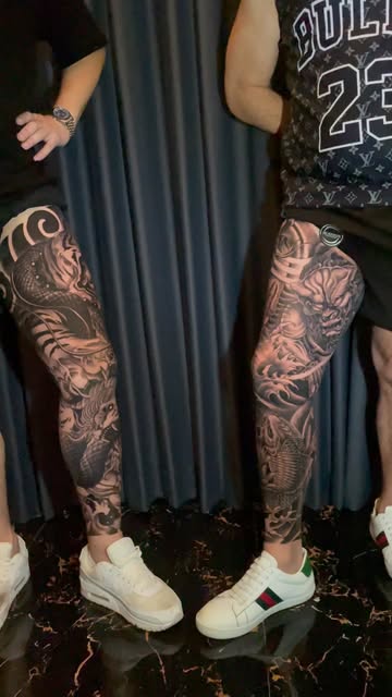Two matching dragon leg sleeves in black and grey