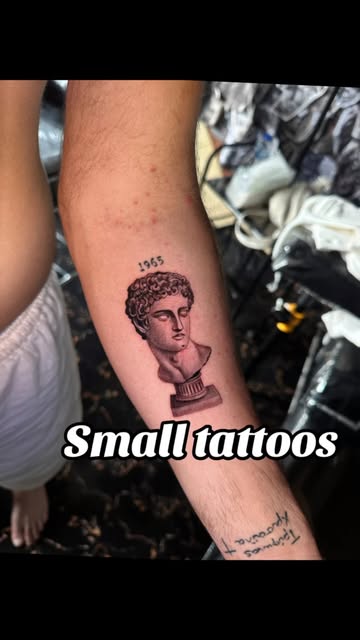 Small fine line forearm tattoo of a classical bust