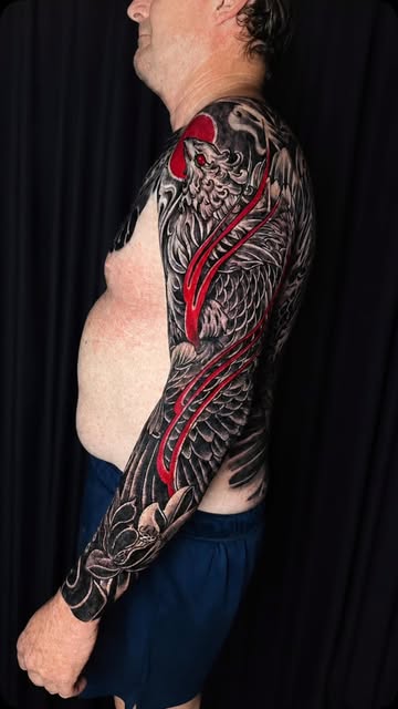 Phoenix arm sleeve in black and grey with red accents